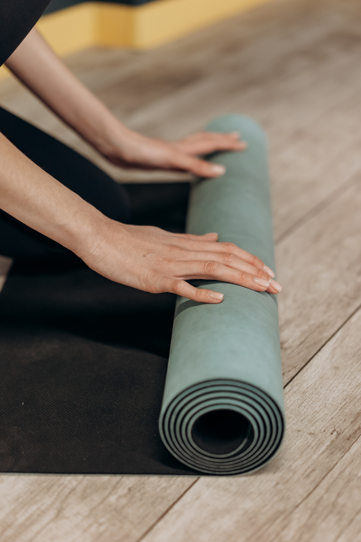 Woman Unrolling A Yoga Mat